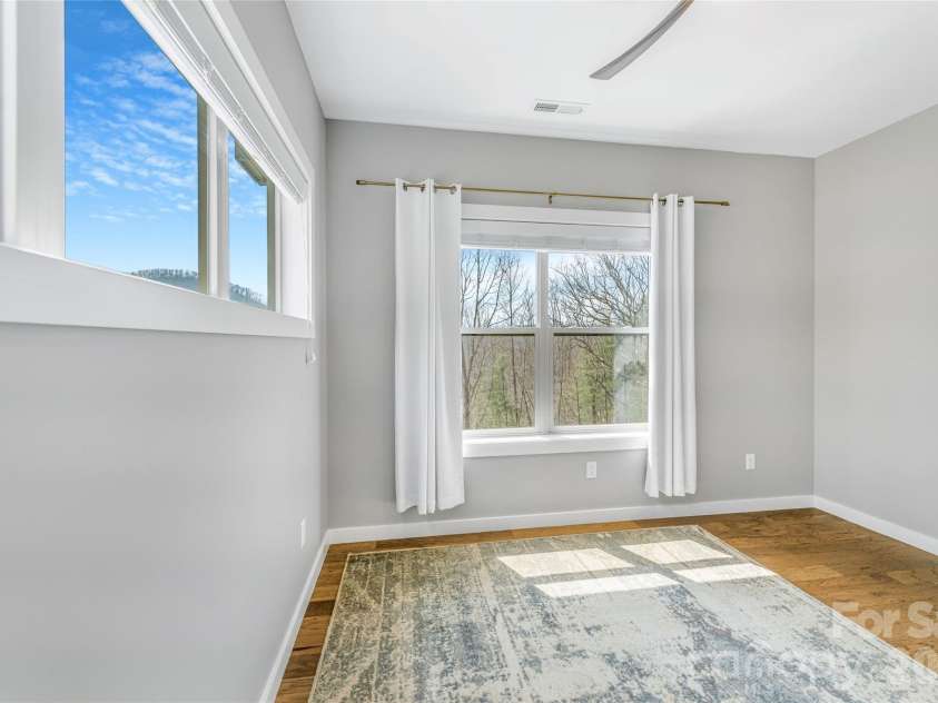 54 Weldon Way, Fairview, NC 28730.  MLS# CAR4353772, YatesRealty ID 22380. Main level bedroom includes transom windows allowing for natural light and privacy. 
