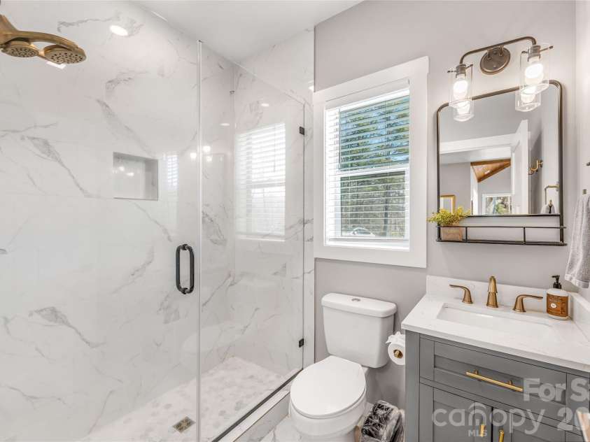 54 Weldon Way, Fairview, NC 28730.  MLS# CAR4353772, YatesRealty ID 22380. Main level spa-like bathroom with a walk-in shower. 