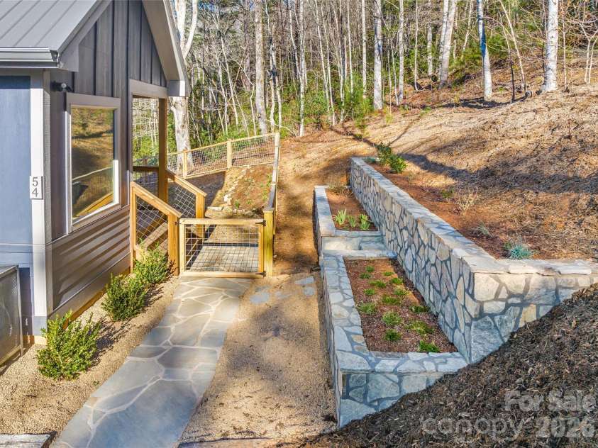 54 Weldon Way, Fairview, NC 28730.  MLS# CAR4353772, YatesRealty ID 22380. New retaining wall raised beds allows for easy gardening. 