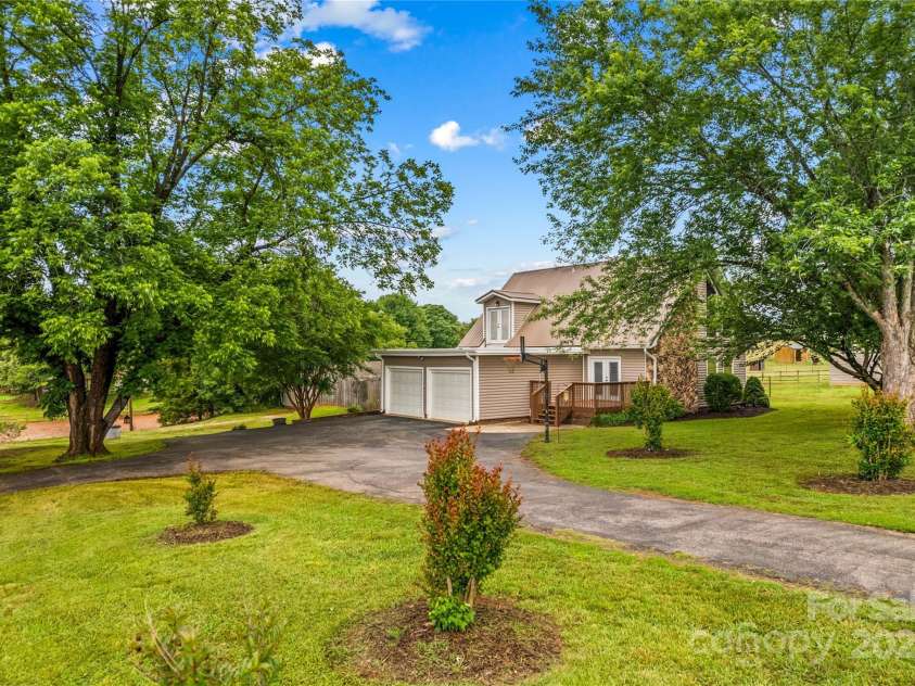 296 Hicks Creek Road, Troutman, NC 28166.  MLS# CAR4266143, YatesRealty ID 22382. Mature shade trees beside the Home