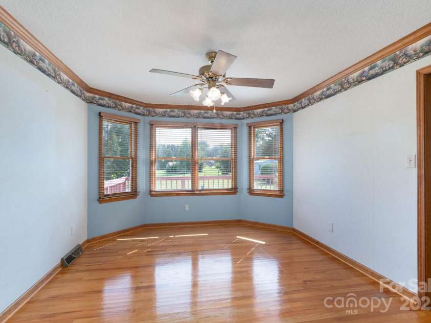 5211 Spring Glen, York, SC 29745.  MLS# CAR4270474, YatesRealty ID 22392. Formal dining room with bayed windows with tons of natural lighting.  Ceiling fan and gleaming hardwood floors!