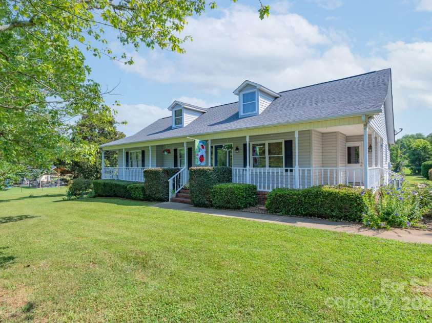 5211 Spring Glen, York, SC 29745.  MLS# CAR4270474, YatesRealty ID 22392. Full view of this beautifully maintained home with a full rocking chair front porch!