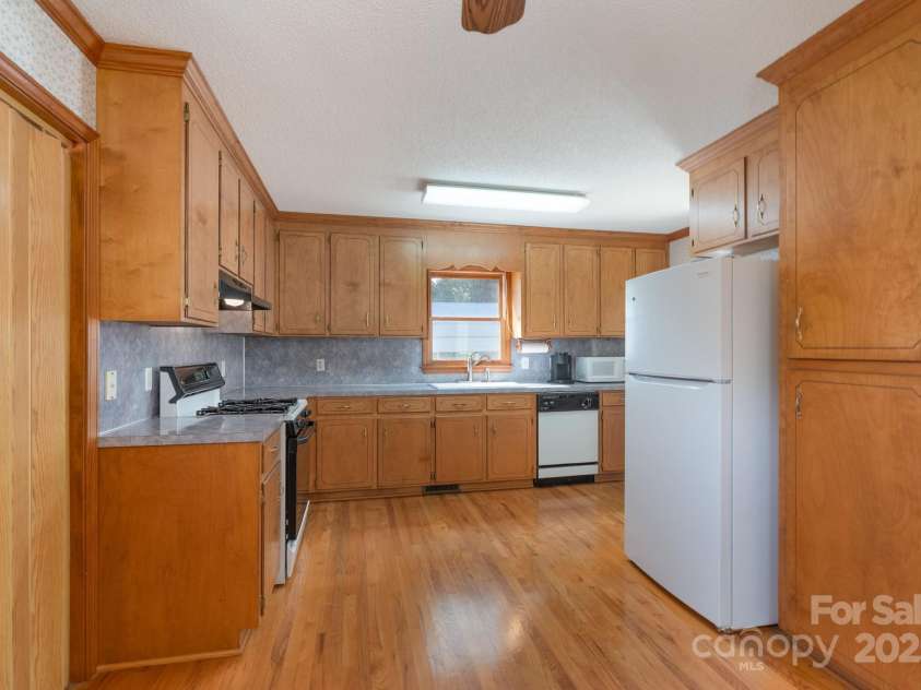 5211 Spring Glen, York, SC 29745.  MLS# CAR4270474, YatesRealty ID 22392. Kitchen area with lots of cabinets and gleaming hardwoods