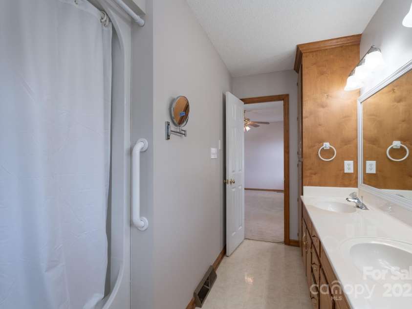 5211 Spring Glen, York, SC 29745.  MLS# CAR4270474, YatesRealty ID 22392. Primary bathroom with double sinks and built in cabinets for linens