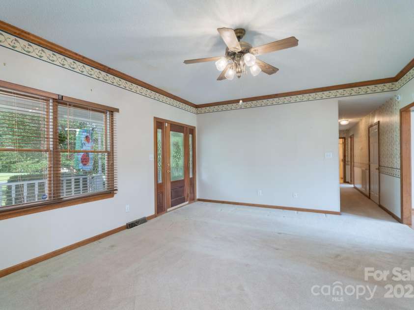 5211 Spring Glen, York, SC 29745.  MLS# CAR4270474, YatesRealty ID 22392. Spacious living Room with ceiling fan, carpet, and beautiful lead glass door with sidelights