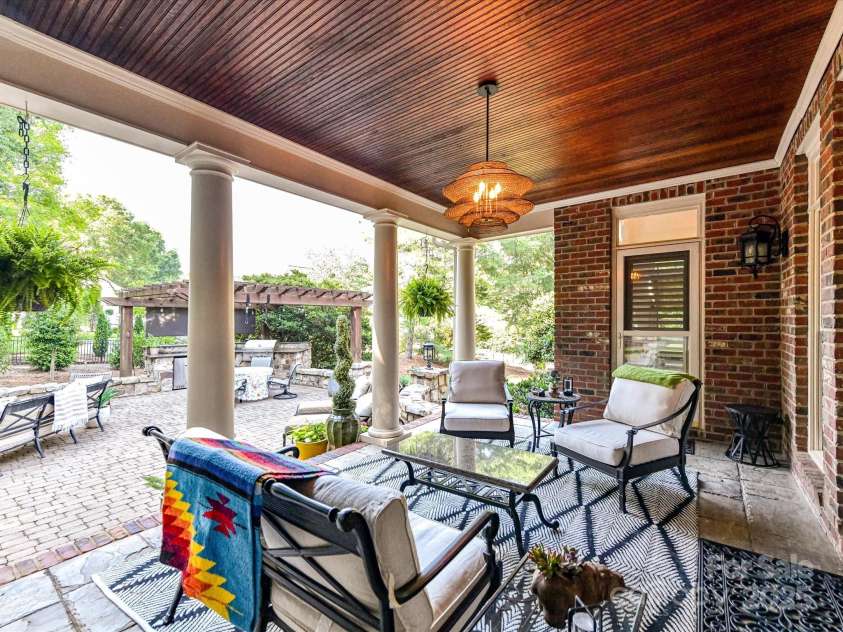 15009 Fanning Manor Court, Charlotte, NC 28277.  MLS# CAR4272630, YatesRealty ID 22393. Back covered Porch- note the chic lighting!