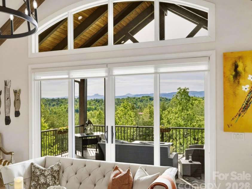1506 High Valley Way, Lenoir, NC 28645.  MLS# CAR4361930, YatesRealty ID 22404. Spellbinding, layered long range mountain views include Table Rock, Brown Mountain, and more.   A wide transom window crowns the space, bathing the interior in more soft, natural light.