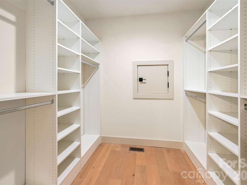 30 Sand Hill Road, Asheville, NC 28806.  MLS# CAR4382772, YatesRealty ID 22422. Basement closet with crawlspace access