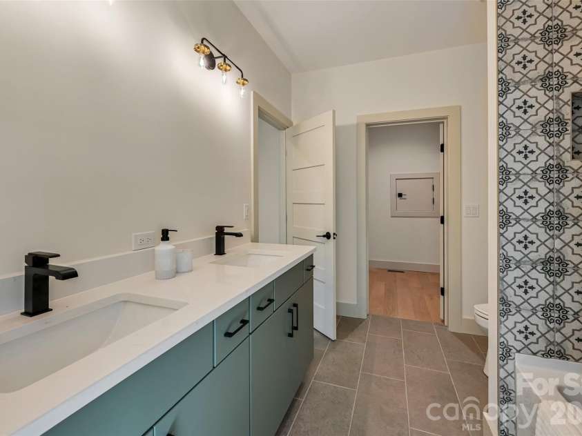 30 Sand Hill Road, Asheville, NC 28806.  MLS# CAR4382772, YatesRealty ID 22422. Basement full bath with double floating vanity