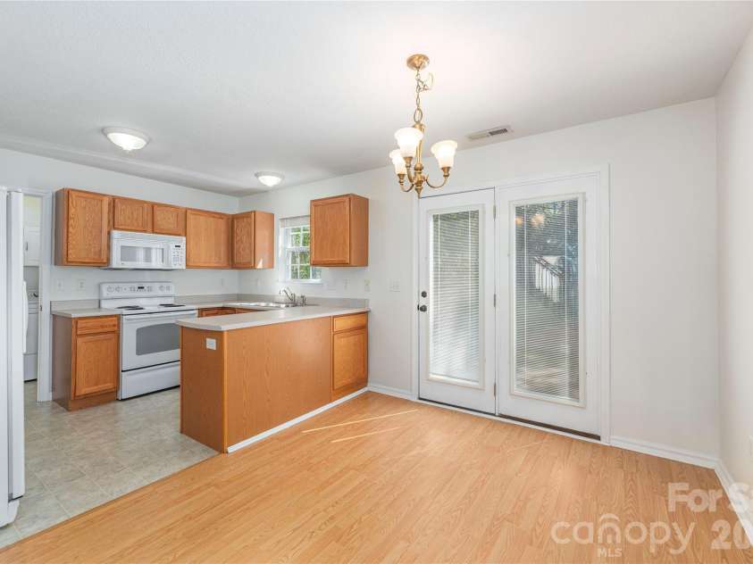 46 Chesire Way, Fletcher, NC 28732.  MLS# CAR4373703, YatesRealty ID 22434. Open dining/ kitchen area, with back patio access.