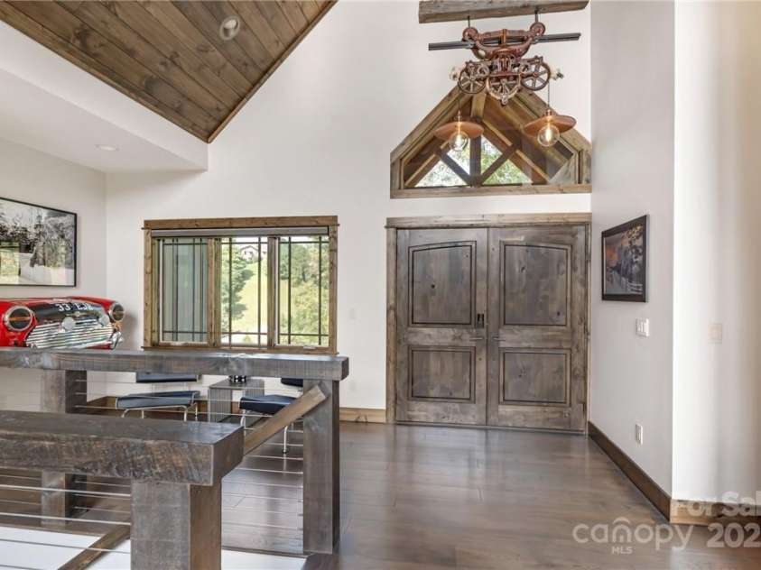 706 Silver Springs Drive, Banner Elk, NC 28604.  MLS# CAR4275009, YatesRealty ID 22440. Entry with Car Bar sitting area