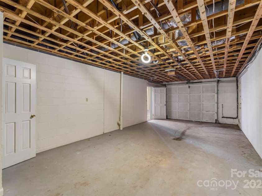 684 Woodfield Drive, Waynesville, NC 28786.  MLS# CAR4269678, YatesRealty ID 22443. 1-car garage in basement includes closet for storage.