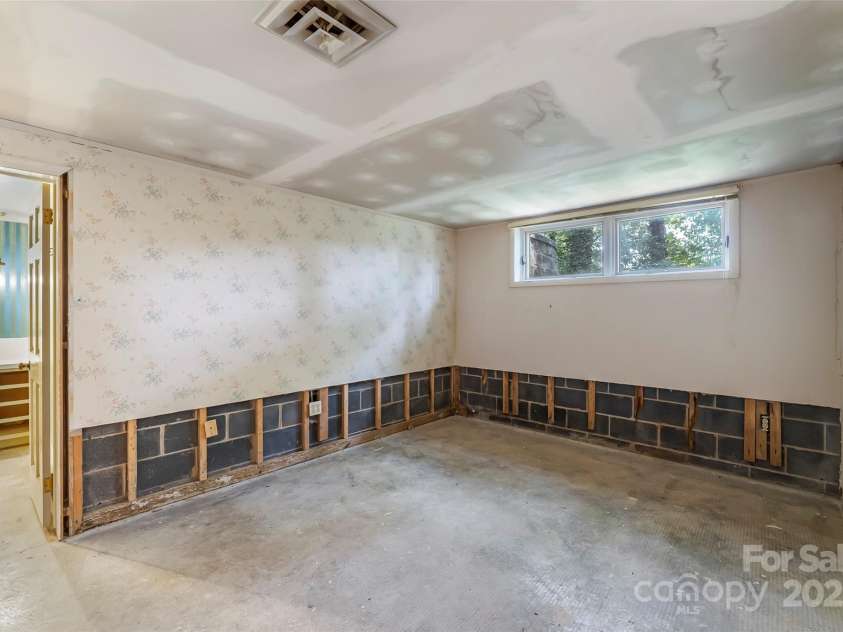684 Woodfield Drive, Waynesville, NC 28786.  MLS# CAR4269678, YatesRealty ID 22443. Basement apartment bedroom ready for renovation