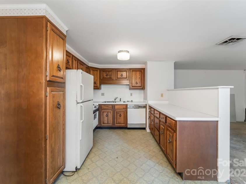684 Woodfield Drive, Waynesville, NC 28786.  MLS# CAR4269678, YatesRealty ID 22443. Basement apartment kitchen ready for your renovation vision!