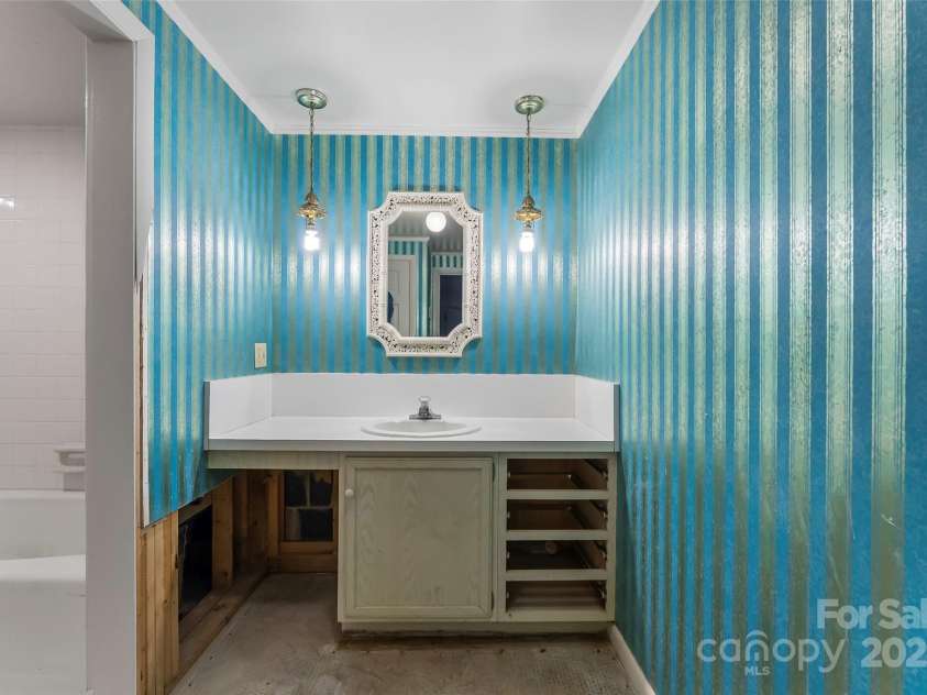 684 Woodfield Drive, Waynesville, NC 28786.  MLS# CAR4269678, YatesRealty ID 22443. Basement apartment vanity next to full bath - renovation-ready!