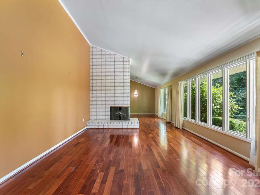 684 Woodfield Drive, Waynesville, NC 28786.  MLS# CAR4269678, YatesRealty ID 22443. Front living room with large windows to showcase beautiful green yard