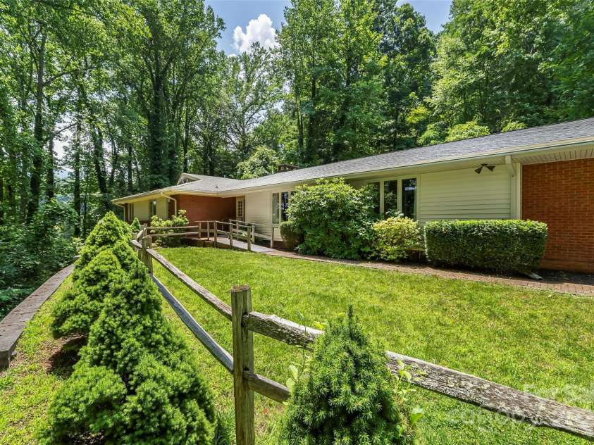 684 Woodfield Drive, Waynesville, NC 28786.  MLS# CAR4269678, YatesRealty ID 22443. Front of home with lovely yard space