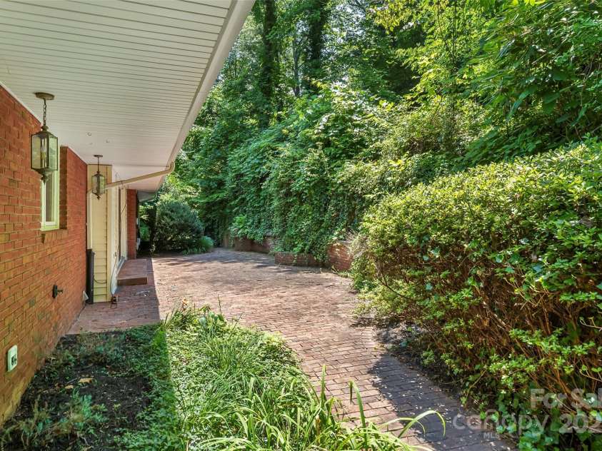 684 Woodfield Drive, Waynesville, NC 28786.  MLS# CAR4269678, YatesRealty ID 22443. Gorgeous brick patio at back of home!