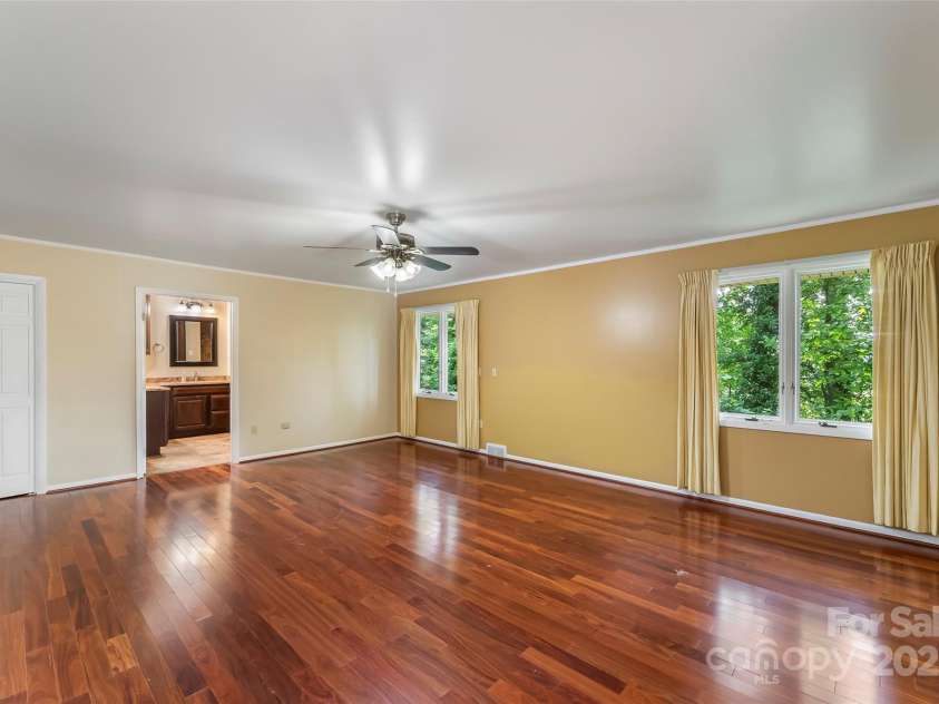 684 Woodfield Drive, Waynesville, NC 28786.  MLS# CAR4269678, YatesRealty ID 22443. Primary bedroom suite with en suite bath and beautiful windows to bring in natural light