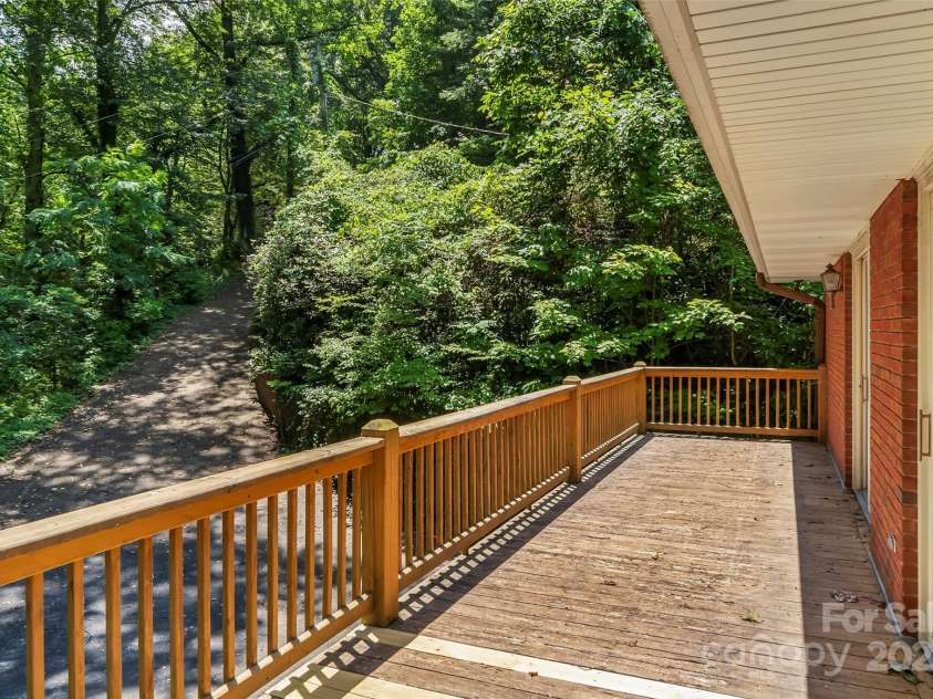 684 Woodfield Drive, Waynesville, NC 28786.  MLS# CAR4269678, YatesRealty ID 22443. View of 2nd driveway to basement apartment from upper deck.