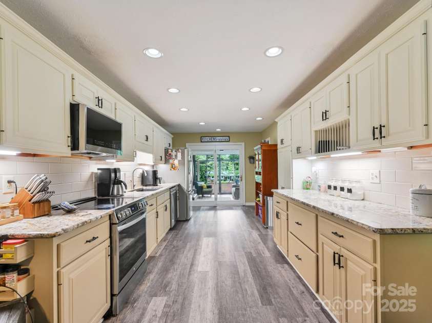 3221 Debbie Drive, Hendersonville, NC 28791.  MLS# CAR4255457, YatesRealty ID 22453. Kitchen View To the Sunroom