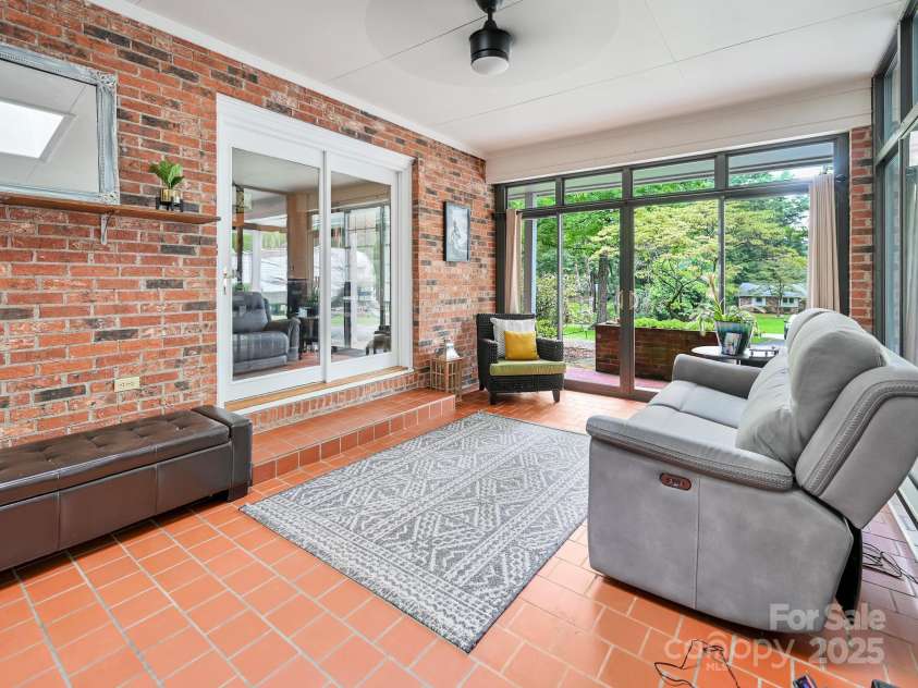 3221 Debbie Drive, Hendersonville, NC 28791.  MLS# CAR4255457, YatesRealty ID 22453. Relaxing Sunroom