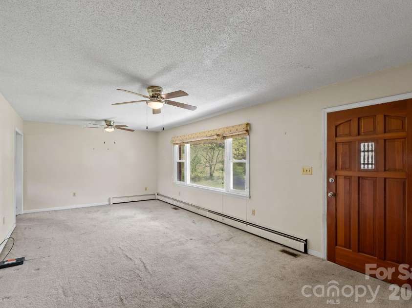 52 Will Smith Lane, Leicester, NC 28748.  MLS# CAR4379317, YatesRealty ID 22454. Front Door Entry to Living Room