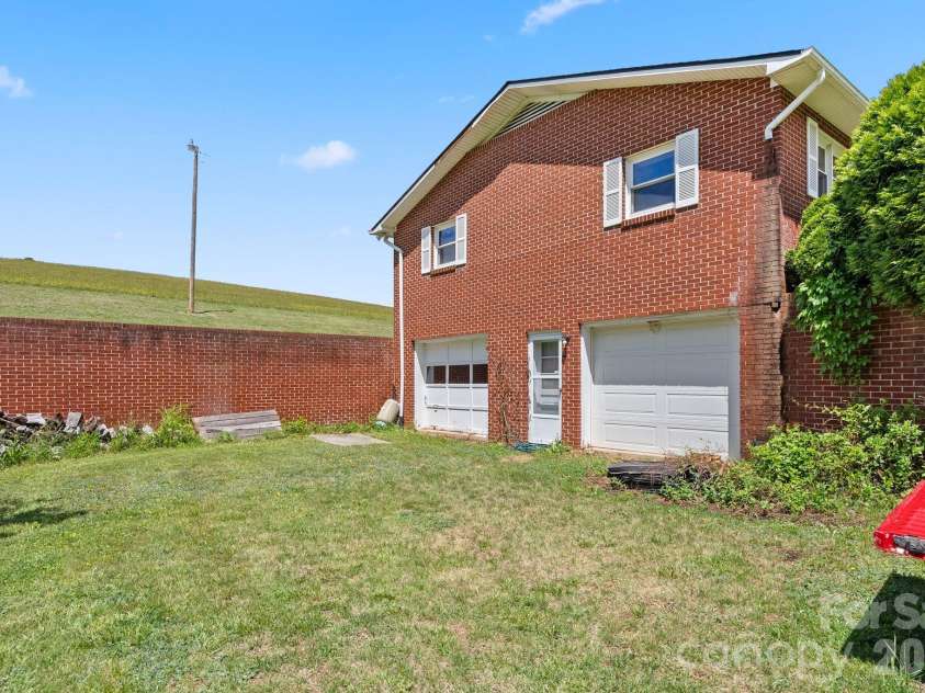 52 Will Smith Lane, Leicester, NC 28748.  MLS# CAR4379317, YatesRealty ID 22454. Two car garage on basement level.