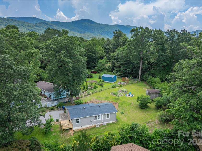 406 Melody Circle, Swannanoa, NC 28778.  MLS# CAR4273532, YatesRealty ID 22466. Drone Photo of Home and surrounding mountains