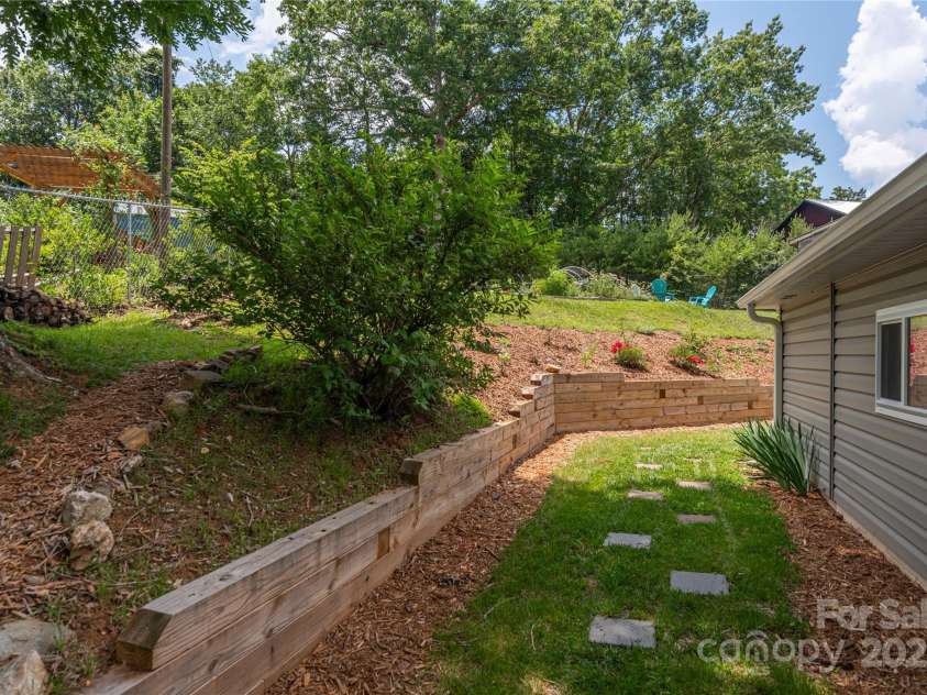406 Melody Circle, Swannanoa, NC 28778.  MLS# CAR4273532, YatesRealty ID 22466. Pathway to separate entrance for home office