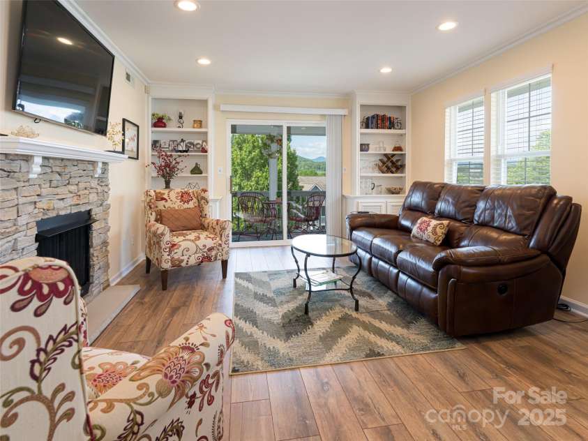 4506 Breakers Lane, Asheville, NC 28806.  MLS# CAR4273310, YatesRealty ID 22485. Family room complete with built in book cases.