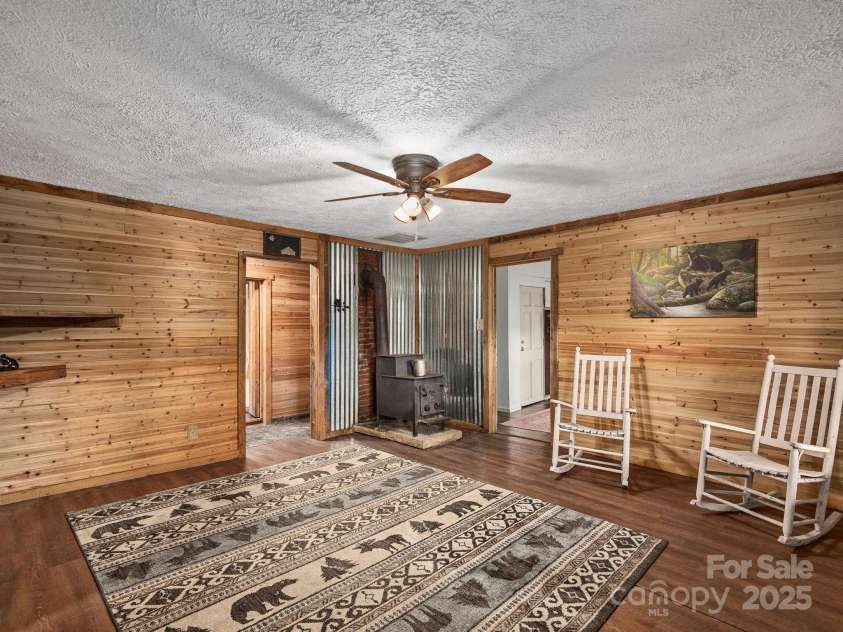 32 Saunooke Road, Asheville, NC 28805.  MLS# CAR4326581, YatesRealty ID 22486. Cozy Living Room with Wood Stove 