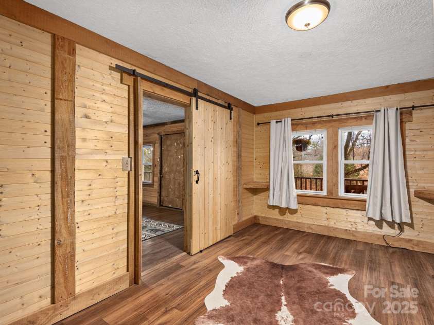 32 Saunooke Road, Asheville, NC 28805.  MLS# CAR4326581, YatesRealty ID 22486. Gorgeous Bedroom One with Barn Door 