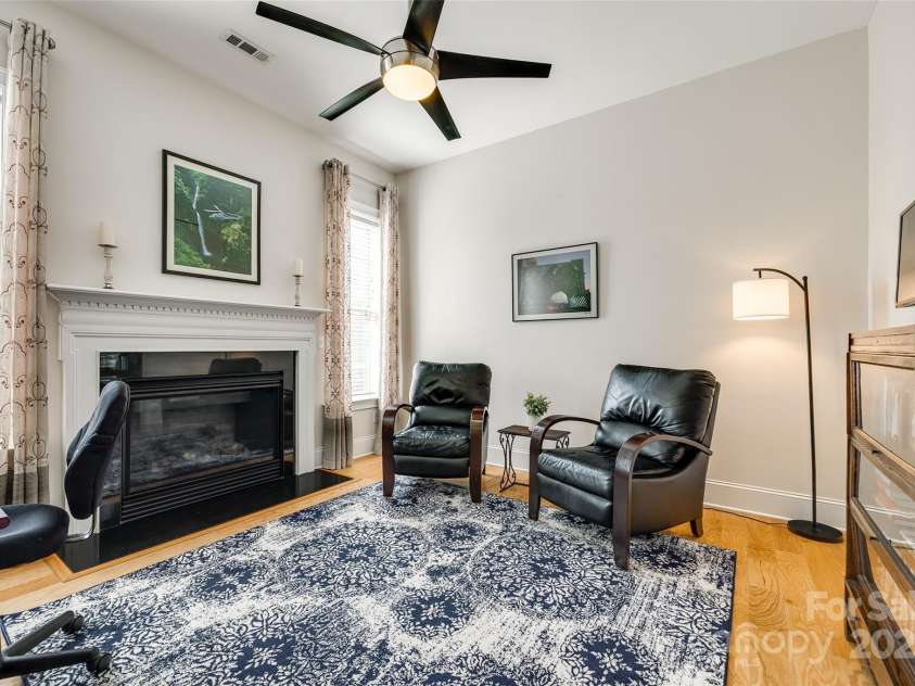 15620 Lake Ridge Road, Charlotte, NC 28278.  MLS# CAR4238155, YatesRealty ID 22515. Designed for productivity, this study/office provides ample space for a desk, bookshelves, and other necessary furnishings. The centerpiece of this room is the charming, natural gas burning fireplace, creating a warm
