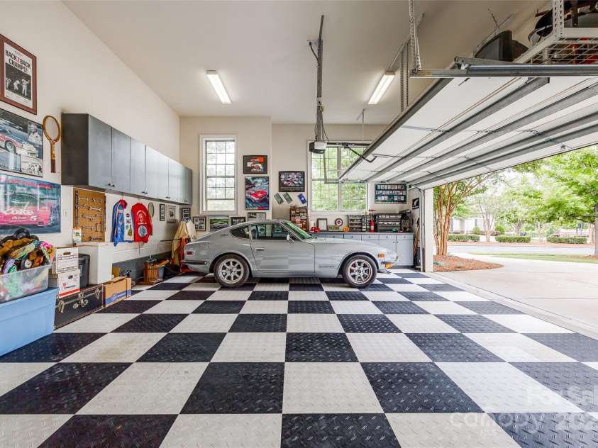 15620 Lake Ridge Road, Charlotte, NC 28278.  MLS# CAR4238155, YatesRealty ID 22515. This oversized garage is a true automotive enthusiast's haven, offering ample room for your prized collection. With enough space for three vehicles, you can finally house your classic car, your daily driver, and mayb