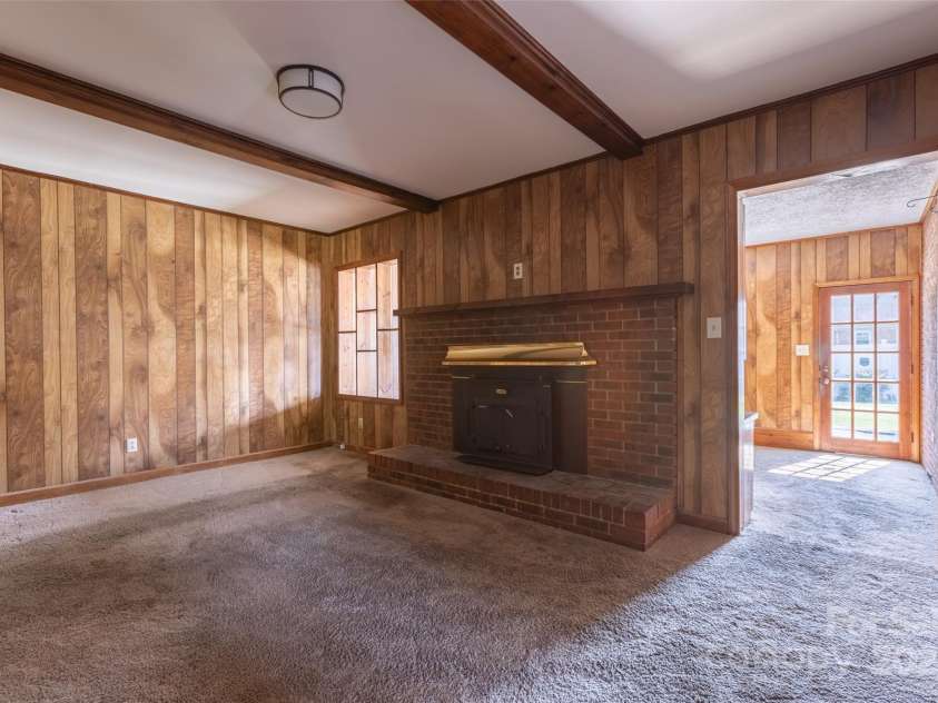 1280 Queensgate Street, Gastonia, NC 28054.  MLS# CAR4272559, YatesRealty ID 22518. Den in center of home with woodstove