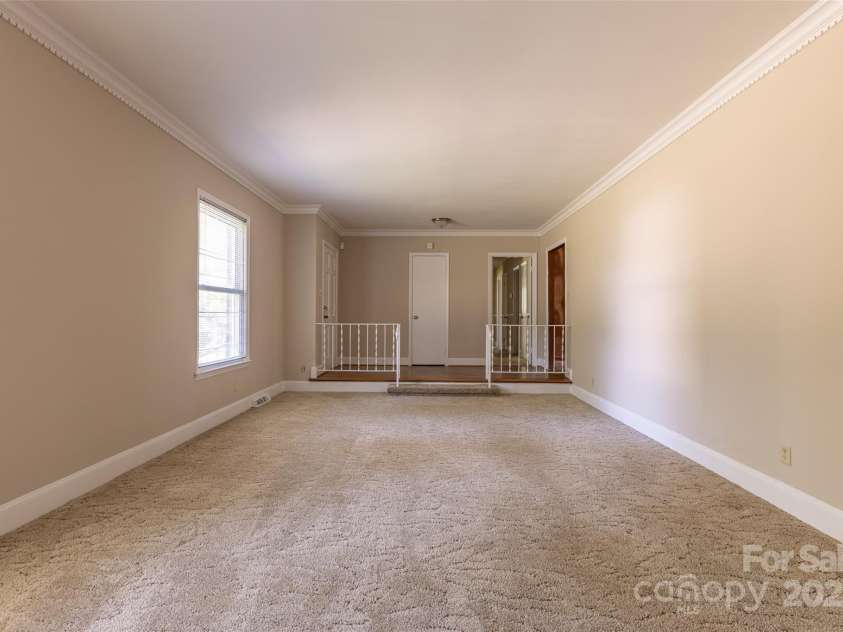 1280 Queensgate Street, Gastonia, NC 28054.  MLS# CAR4272559, YatesRealty ID 22518. View of living room and foyer from the dining area of the dining/living combo room