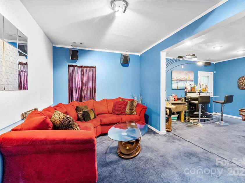 8619 Delamere Lane, Charlotte, NC 28269.  MLS# CAR4241506, YatesRealty ID 22527. Basement level sitting area furnished -