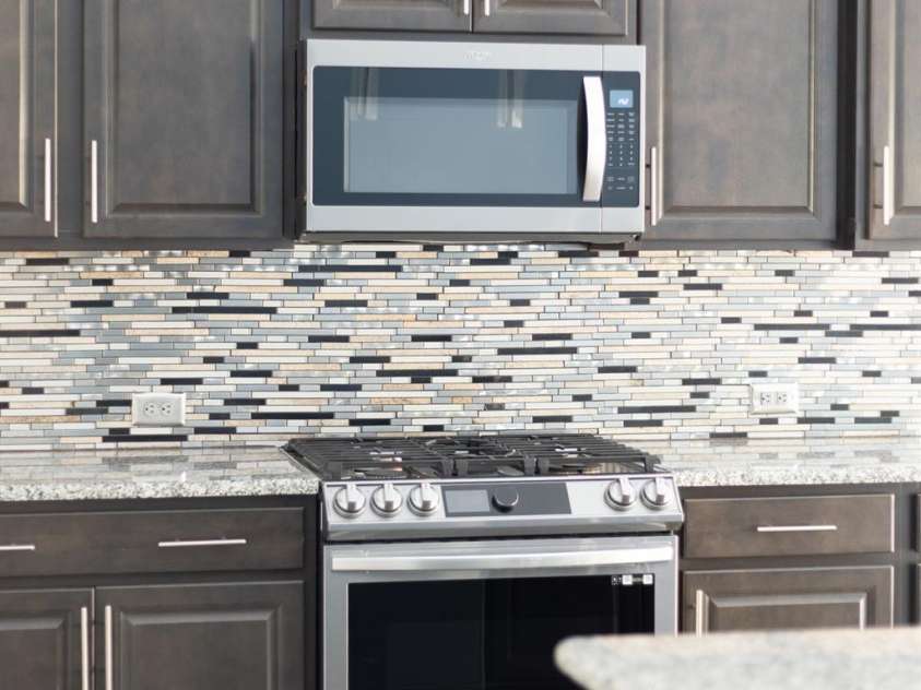 202 Paradise Hills Circle, Mooresville, NC 28115.  MLS# CAR4329082, YatesRealty ID 22528. The kitchen features a sleek Samsung smart gas range with a five-burner cooktop, built-in griddle/grill, multiple oven modes, including convection and air fry, and Wi-Fi connectivity.