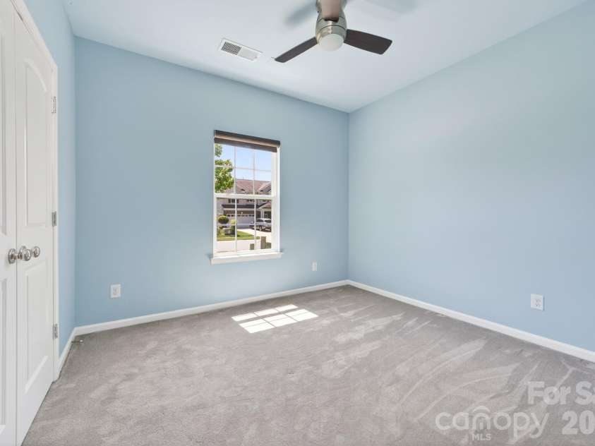 202 Paradise Hills Circle, Mooresville, NC 28115.  MLS# CAR4329082, YatesRealty ID 22528. The secondary bedrooms offer modern finishes that blend style with everyday utility, featuring upgraded lighting and ceiling fans with handheld remote controls, and oversized closets featuring professional orga