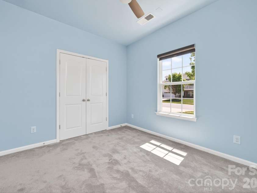 202 Paradise Hills Circle, Mooresville, NC 28115.  MLS# CAR4329082, YatesRealty ID 22528. The secondary bedrooms offer modern finishes that blend style with everyday utility, featuring upgraded lighting and ceiling fans with handheld remote controls, and oversized closets featuring professional orga