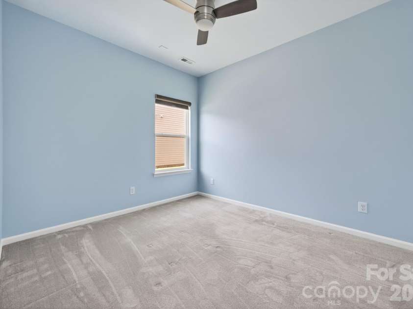 202 Paradise Hills Circle, Mooresville, NC 28115.  MLS# CAR4329082, YatesRealty ID 22528. The secondary bedrooms offer modern finishes that blend style with everyday utility, featuring upgraded lighting and ceiling fans with handheld remote controls, and oversized closets featuring professional orga