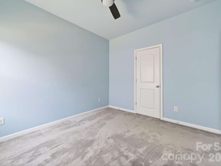 202 Paradise Hills Circle, Mooresville, NC 28115.  MLS# CAR4329082, YatesRealty ID 22528. The secondary bedrooms offer modern finishes that blend style with everyday utility, featuring upgraded lighting and ceiling fans with handheld remote controls, and oversized closets featuring professional orga