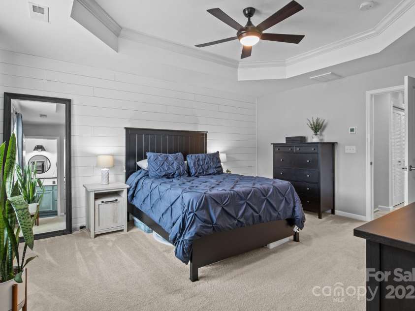 2444 Mariners Cove Lane, Denver, NC 28037.  MLS# CAR4259617, YatesRealty ID 22530. Large primary bedroom with tray ceilings and shiplap accent wall.