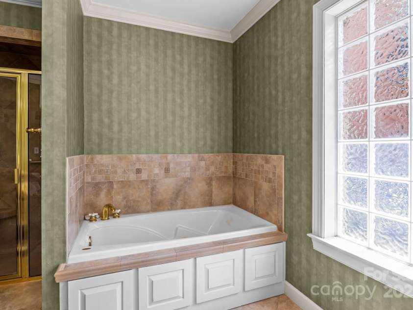 3209 Sedgefield Road, Statesville, NC 28625.  MLS# CAR4259926, YatesRealty ID 22531. Ensuite walk-in shower and bathtub.