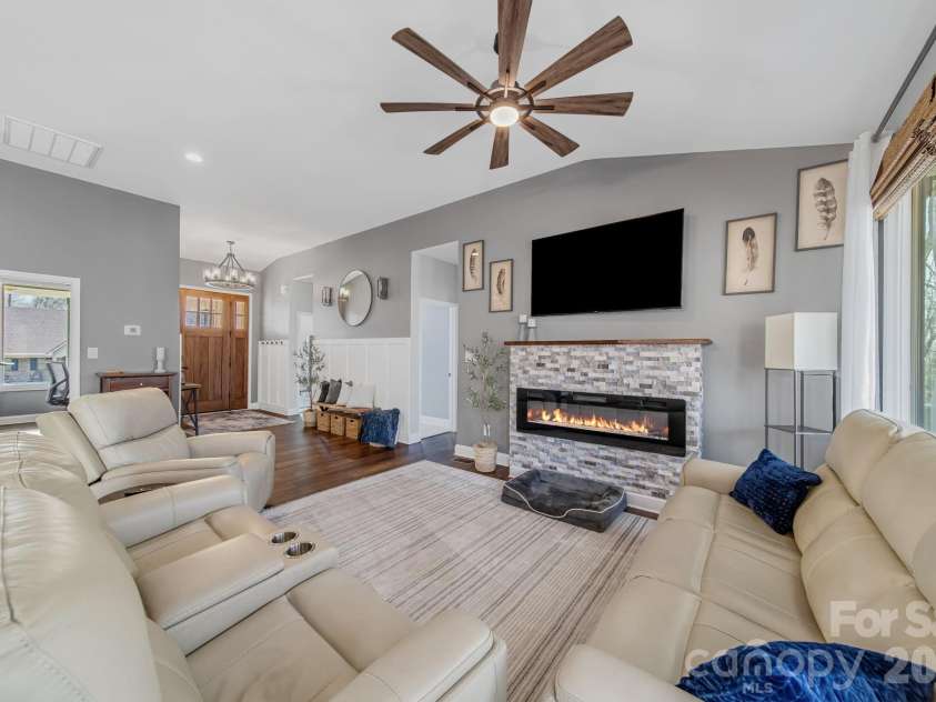 128 Laurel Ridge Drive, Statesville, NC 28677.  MLS# CAR4346436, YatesRealty ID 22532. Cozy living room with rock fireplace with electric flame.  