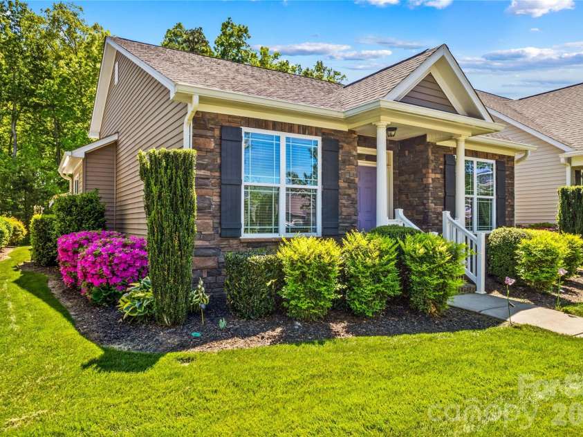 11516 Dublin Crescent Road, Cornelius, NC 28031.  MLS# CAR4369660, YatesRealty ID 22543. Beautiful landscaping surrounds the home with lush green grass maintained using the in-ground irrigation system.