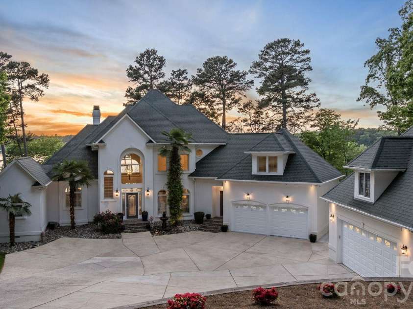 144 Mariner Pointe Lane, Mooresville, NC 28117.  MLS# CAR4336231, YatesRealty ID 22545. Exterior view at sunset.