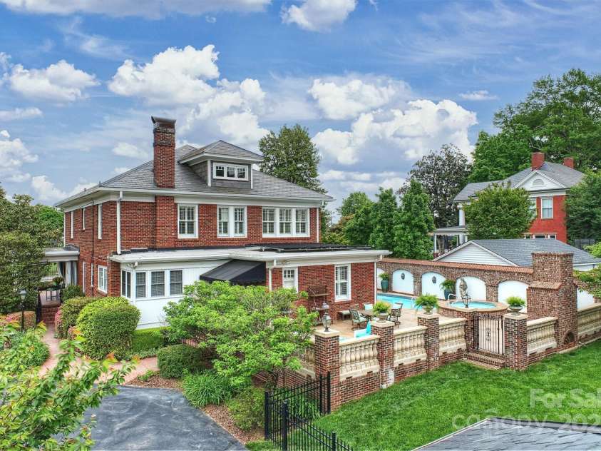 215 Main Street, Belmont, NC 28012.  MLS# CAR4134774, YatesRealty ID 22545. Aerial rear view of home showing mature landscaping and 2126 Sf Pool terrace.  Home has been loving cared for by current owners for 25 years!  It's an amazing home/yard for entertaining year around!