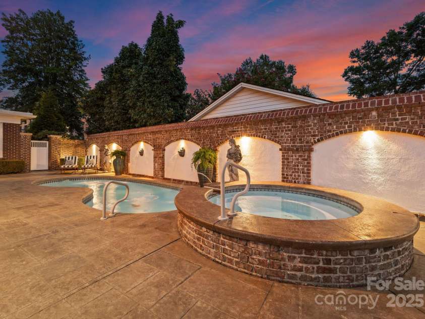 215 Main Street, Belmont, NC 28012.  MLS# CAR4134774, YatesRealty ID 22545. Charleston inspired pool! The white gate in the background leads to a secret garden path, fully landscaped and opening under an arch to the front yard.  There is also access to the rear yard from the 2126SF terrace.  The arc